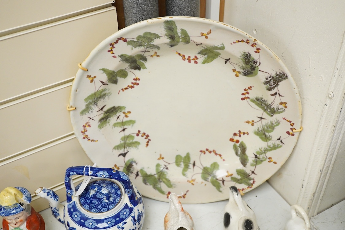 A large collection of English pottery cow creamers, Staffordshire figures and cruets a blue and white teapot and sponge ware dish-34cm diameter, (26)
